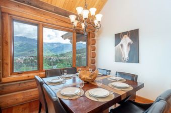 The dining area at Townhomes on the Creek 117 is warm and inviting with seating for eight and beautiful views.