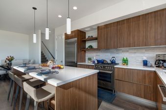Abode at Viridian showcases a modern kitchen with a large island perfect for dining.