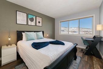 Bedroom in Summit Unit 1103 with a large window.