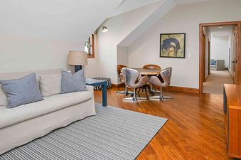 Ritz Carlton Vail 402 has a comfortable living room area with a couch, a TV, a wood floor, a carpet, and a coffee table.