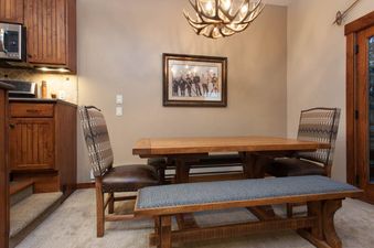 Dining table and chairs under an antler chandelier in Kutuk 212.