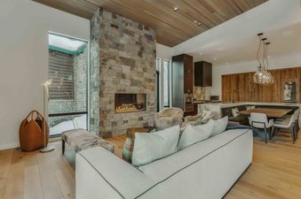 The Frostline in West Vail boasts a stunning living area with a stone fireplace and views.