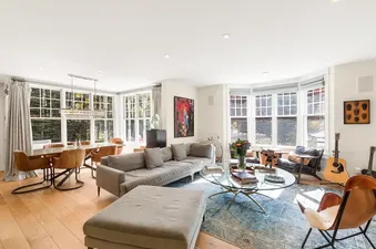 Bright and spacious open-concept living and dining area in Park Place in Telluride with modern furniture and large windows.