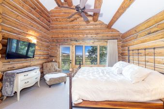 The bedroom in 267 Country Club is beautifully furnished and decorated with knotty pine.