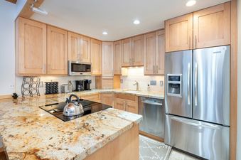 A modern kitchen with stainless steel appliances and granite countertops.