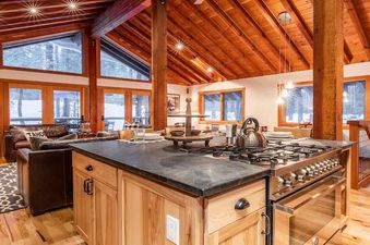 A kitchen with wood floors, a large island, and stainless steel appliances.