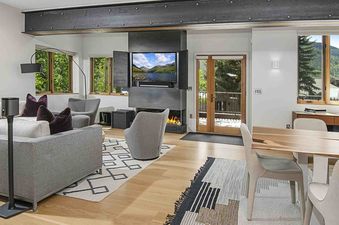 The living room of 1175 A Casolar Del Norte features a fireplace, a large flat screen TV, and a couch.