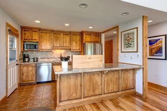 Fully Equipped Kitchen with Stainless Steel Appliances and Side Patio Access