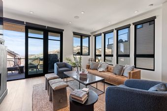 The living area of Powder Peak Old Town features large windows and comfortable seating.