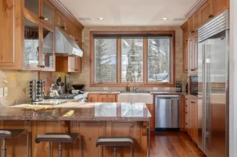 Gourmet kitchen with wood cabinetry and stainless steel appliances at Ascent at Aspen Ridge.
