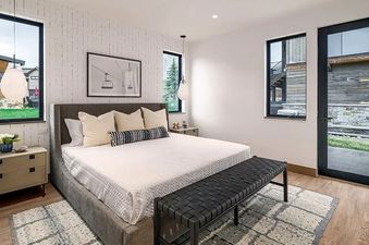 An upside-down bedroom in the Wildhorse Preserve 6 Bedroom features a bed suspended from the ceiling, with a white mattress, grey frame, and striped pillows.