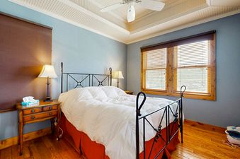 The bedroom in Quittin Time on Woodside is well-lit and inviting.