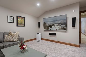 The entertainment area in Grand Lodge 5 Bedroom Penthouse 504 features a large flat-screen television, a comfortable couch, and a coffee table.