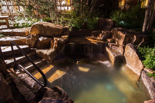 Outdoor waterfall hot tub