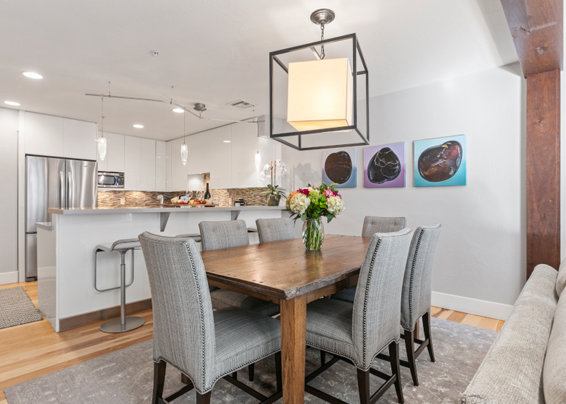 The dining room at Lodges at Deer Valley 2 Bedroom Suite features a wood table and six chairs.