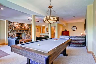 The Snow Mountain Lodge's game room features a pool table with grey felt.