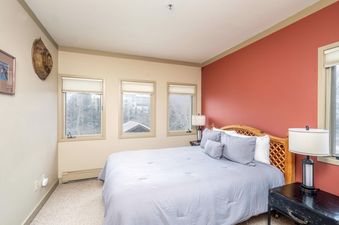 Comfortable bedroom in Shirana 1 with a well-made bed and natural light.