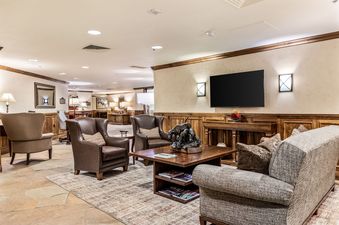 The elegant lounge area at Sunstone Chalet at One Beaver Creek features comfortable seating, a large TV, and tasteful decor.