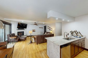 The living area in Phoenix 107 features a fireplace, large windows, and a comfortable seating area.