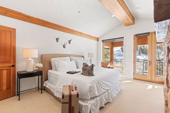 A bedroom in Abode at Sterling Lodge with a white bed and natural light.