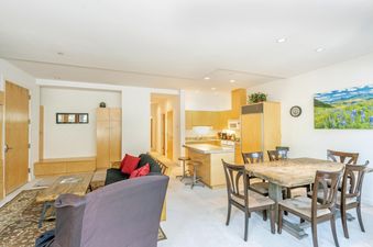 The living and dining area of Willow 302 is bathed in natural light.