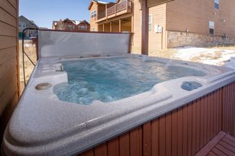 The Hot Tub at 67 Fireweed 27A is perfectly set for a relaxing soak, with steaming water and a clear view of the surrounding snow-dusted landscape and neighboring homes.