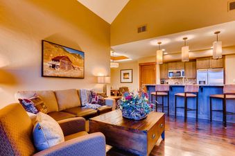 A cozy living area flows into the kitchen in One Ski Hill Penthouse.