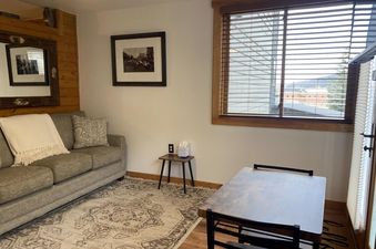 The inviting living space at Tomboy Lodge 138 features comfortable seating and natural light.