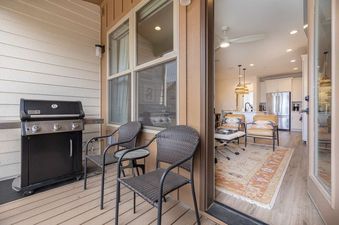 The balcony at Stage Coach with a gas grill and woven chairs.