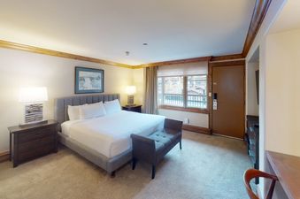 Manor Vail 118 features a king bed, a dresser and a small bench in the bedroom.