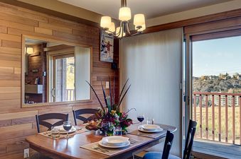 The dining area is warmly lit and inviting, perfect for meals at Bear Claw 1 Slope View 203.