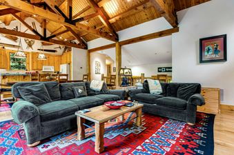 Living room area at 3137 Arrowhead with sofas and wood accents.