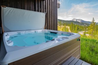Enjoy a relaxing soak in the private hot tub at Moonlight Basin 6A Treeline Springs, with stunning mountain views as your backdrop.