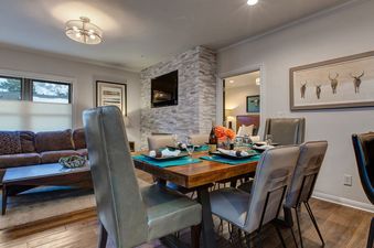 A beautifully decorated dining room features a table set for a special occasion.