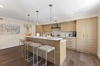 The kitchen at Abode at Sky Silver features a breakfast bar, modern appliances, and updated cabinets.