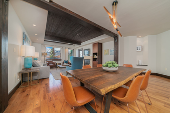 Spacious dining area with a large wooden table and leather chairs