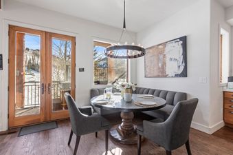 Dining nook at Abode at Sterling Lodge with a round table and banquette seating.