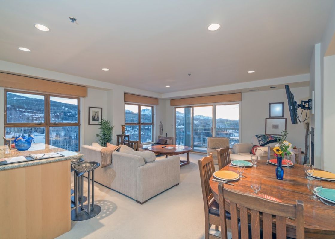 The Penthouse At The Peaks 746 showcases a spacious and bright living area with views of the surrounding mountains.