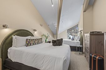 The bedroom in Abode at Little Belle 3 features a plush king-size bed and a twin bed, perfect for families.