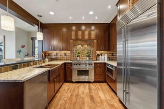 Empire Chalet at Flagstaff Lodge's kitchen boasts modern stainless steel appliances and a copper farmhouse sink, creating a stunning and functional space.