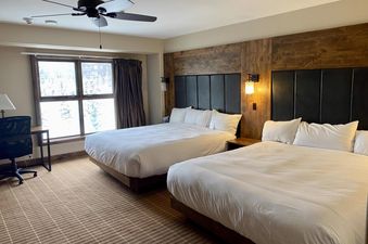A bedroom in Peaks Penthouse 643 with two beds and a window.