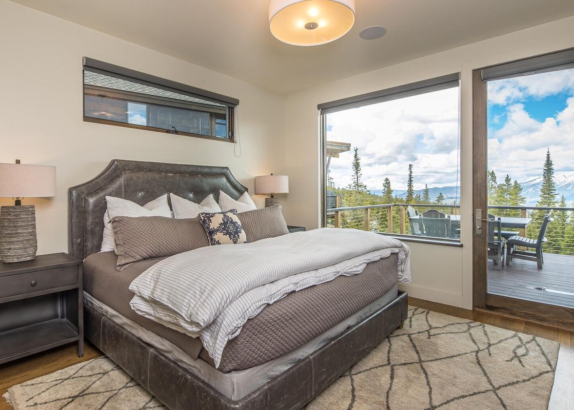 Moonlight Basin 18 Alpine Bend bedroom with king bed, view of mountains, and patio