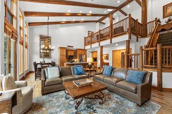 Living area in Timbers 3082 with leather sofas and wooden accents.