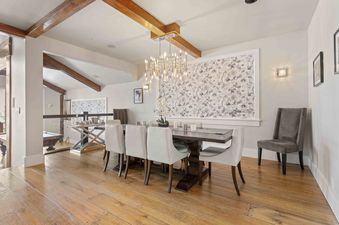 Dining room at 6977 Silver Lake Drive with wood floors and modern chandelier.
