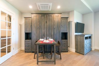 Dining area in Peaks Penthouse 644 with a gray dining table and wooden floors.