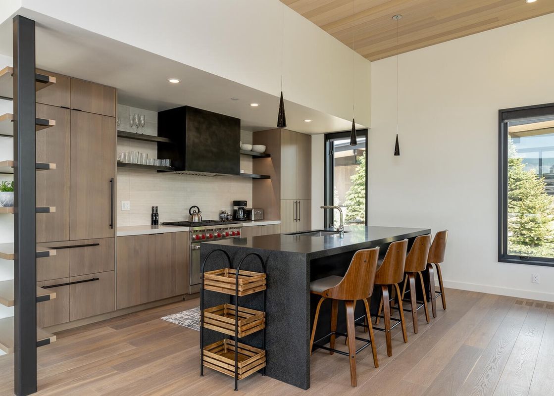 The kitchen in Moonlight Basin 11 Treeline features modern appliances and a large island with bar stools.