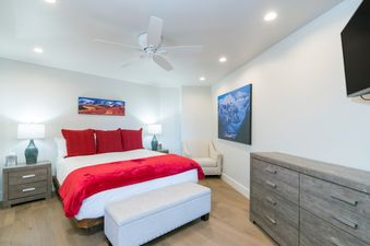 Cozy bedroom with red accents in Peaks Penthouse 644.