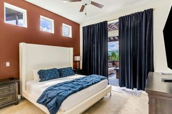 A bedroom with a king-size bed and a view of the mountains from the window