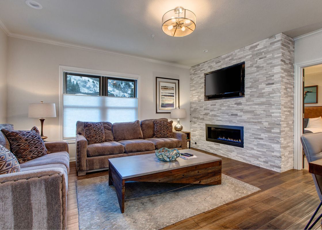 Living room at Abode on Lower Main with fireplace and seating.