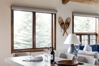 The dining table with concrete top and wooden ceiling in Shooting Star Cabin 01.